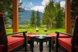Experience breathtaking mountain views from this stunning property's covered porch, perfect for enjoying a glass of wine.