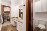 This spacious bathroom features a double vanity with ample counter space and storage, perfect for any household.