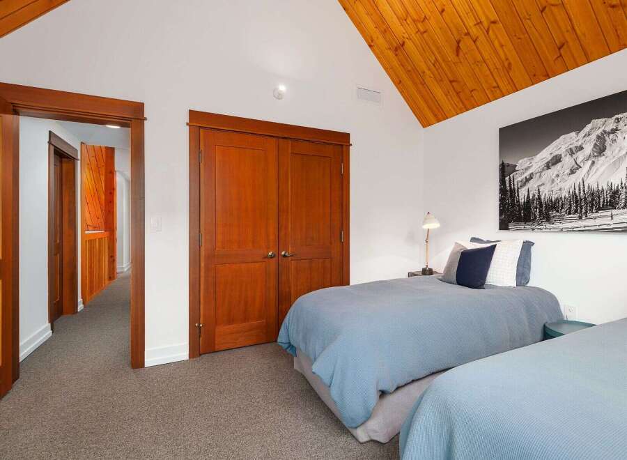 This charming bedroom features two cozy beds with light blue comforters, perfect for a restful night's sleep.