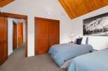 This charming bedroom features two cozy beds with light blue comforters, perfect for a restful night's sleep.