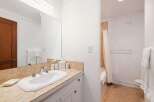 This bathroom features a clean white sink with chrome fixtures set against a tiled backsplash.