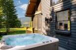 Experience ultimate relaxation in this luxurious hot tub, perfectly situated on a private deck with stunning mountain and lake views.