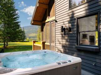 Experience ultimate relaxation in this luxurious hot tub, perfectly situated on a private deck with stunning mountain and lake views.