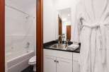 This inviting bathroom features a pristine white bathtub and shower combination, perfect for relaxing soaks or quick rinses.