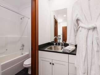 This inviting bathroom features a pristine white bathtub and shower combination, perfect for relaxing soaks or quick rinses.