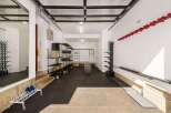 This spacious garage offers ample storage solutions, including multi-tiered shelving units and wall-mounted racks perfect for skis and sports equipment.