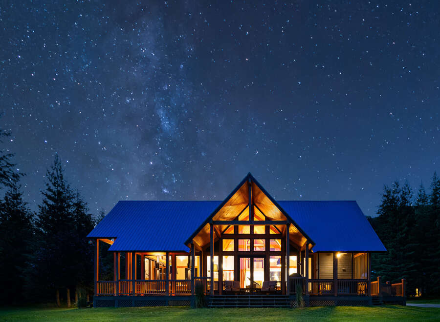 Experience the magic of stargazing from this stunning modern cabin, nestled amongst tall pine trees.