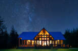 Experience the magic of stargazing from this stunning modern cabin, nestled amongst tall pine trees.