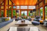 Experience luxury mountain living in this stunning great room, featuring a soaring wood-paneled vaulted ceiling and expansive windows that frame breathtaking panoramic views.