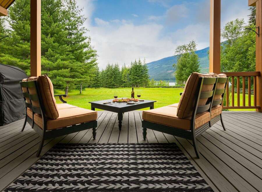 Enjoy breathtaking mountain and lake views from this covered porch, perfect for relaxing or entertaining.