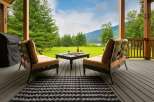 Enjoy breathtaking mountain and lake views from this covered porch, perfect for relaxing or entertaining.