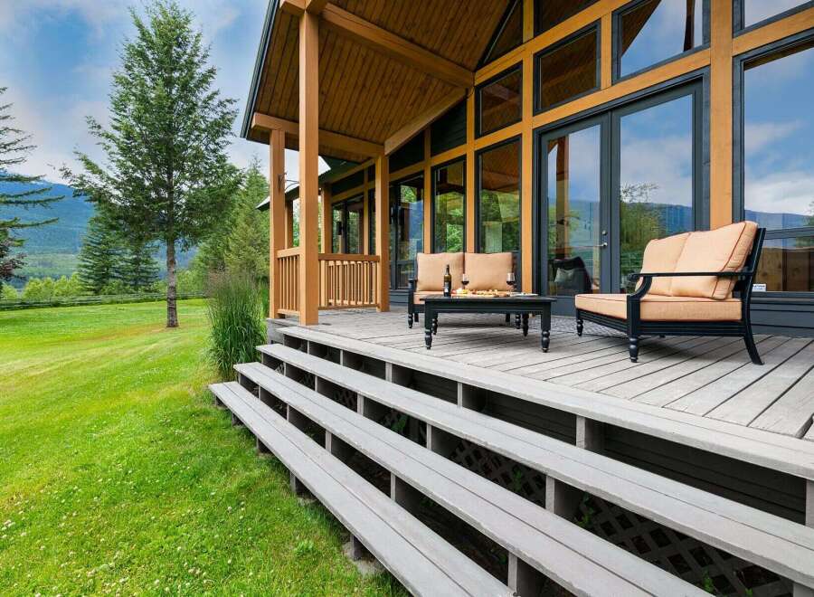 Experience the ultimate in indoor-outdoor living with this stunning property, featuring a spacious wooden deck perfect for entertaining or relaxing.