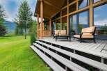 Experience the ultimate in indoor-outdoor living with this stunning property, featuring a spacious wooden deck perfect for entertaining or relaxing.