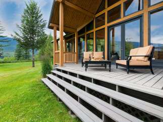 Experience the ultimate in indoor-outdoor living with this stunning property, featuring a spacious wooden deck perfect for entertaining or relaxing.