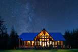 Experience the magic of stargazing from this stunning modern cabin, nestled amongst tall pine trees.
