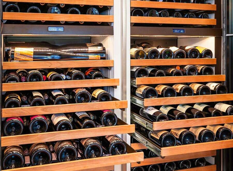 Experience the ultimate in wine preservation with this state-of-the-art dual-zone wine cellar, featuring multiple pull-out wooden shelves designed to store your collection at optimal temperatures.