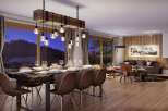 Experience luxurious mountain living in this stunning dining and living area, featuring a rustic wooden dining table set for a feast and a cozy fireplace perfect for chilly evenings.