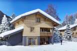Experience the ultimate winter retreat in this stunning wooden chalet, nestled amidst snow-covered pine trees and majestic mountains.