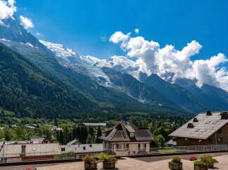 Experience breathtaking mountain views from this stunning property, nestled amidst lush green forests and towering snow-capped peaks.