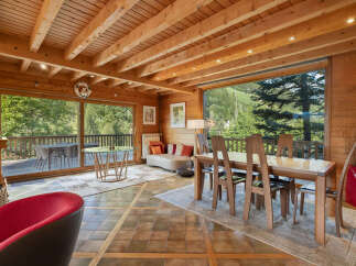 Experience breathtaking mountain views from this stunning dining area, featuring a spacious wooden dining table perfect for family gatherings.