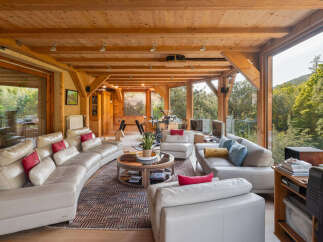 Experience ultimate relaxation in this spacious living area, featuring a large curved sectional sofa perfect for gatherings.
