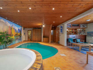 Escape to this unique indoor oasis featuring a sparkling swimming pool and a relaxing hot tub, perfect for year-round enjoyment.