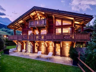 Experience luxury mountain living in this stunning wooden chalet, featuring expansive balconies and large windows that capture breathtaking views.