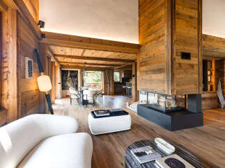 Experience luxurious mountain living in this stunning chalet, featuring a grand fireplace as the centerpiece of the open-concept living area.
