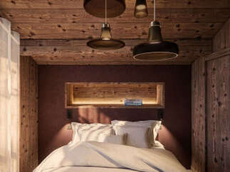 Experience rustic charm and modern comfort in this cozy bedroom, featuring a luxurious bed adorned with plush pillows and a warm, inviting ambiance.