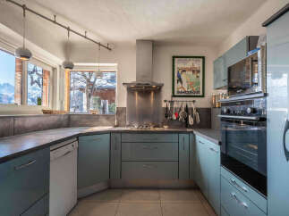 Experience the perfect blend of modern style and functionality in this stunning kitchen, featuring sleek light blue cabinetry and durable concrete countertops.