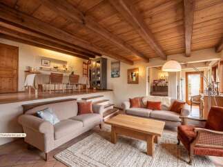 Step into a charming living space featuring a raised dining area with a large table and chairs, perfect for family gatherings.