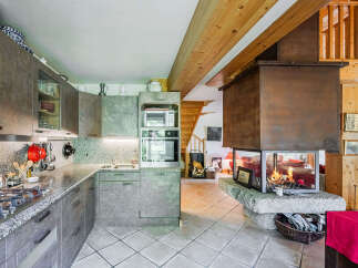 Experience the perfect blend of rustic charm and modern convenience in this stunning kitchen and living area.