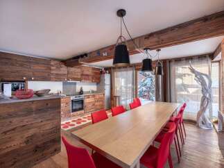 Experience rustic charm and modern comfort in this stunning mountain chalet kitchen and dining area.