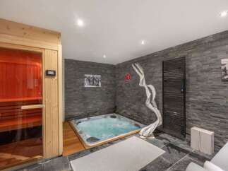 Indulge in ultimate relaxation with this luxurious spa area, featuring a private sauna and a bubbling hot tub.