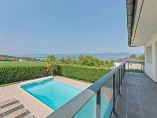 Enjoy breathtaking panoramic views from this stunning property, featuring a pristine swimming pool and a spacious balcony perfect for entertaining.