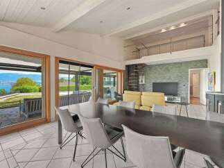 Experience breathtaking lake and mountain views from this stunning modern living space.