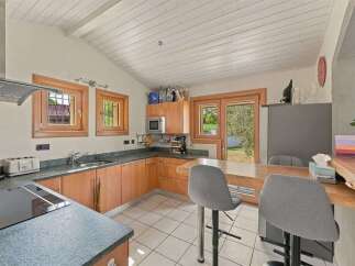 Discover this charming kitchen featuring warm wooden cabinetry and a spacious granite countertop.