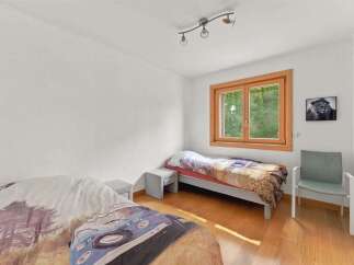 This charming bedroom features two twin beds, perfect for guests or children.