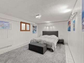 Discover this cozy bedroom featuring a comfortable bed with plush bedding and a stylish headboard.