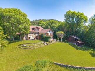 Discover this charming stone house nestled amidst lush greenery, offering a serene retreat.