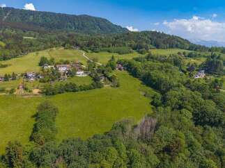 Discover this stunning property nestled in a serene, green landscape with panoramic mountain views.