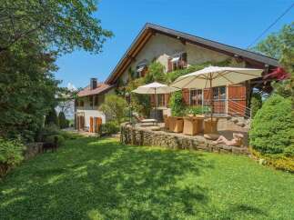 Experience serene living in this charming property featuring a spacious garden and a picturesque patio area perfect for outdoor dining.