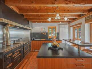 Experience rustic charm in this spacious kitchen featuring a professional-grade range and a large island perfect for meal prep and casual dining.