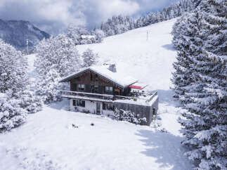 Experience the ultimate winter retreat in this charming alpine chalet, nestled amidst snow-covered trees and majestic mountains.