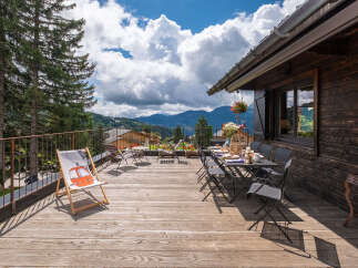 Enjoy breathtaking mountain views from this stunning wooden deck, perfect for al fresco dining or relaxing in the fresh air.