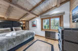 Experience rustic charm in this cozy bedroom, featuring a luxurious faux fur duvet and a stylish upholstered headboard.