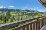 Experience breathtaking mountain views from this charming property, featuring a rustic wooden balcony perfect for enjoying the serene alpine landscape.