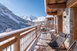Enjoy breathtaking mountain views from this charming balcony, perfect for a winter getaway.