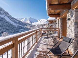 Enjoy breathtaking mountain views from this charming balcony, perfect for a winter getaway.