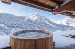 Experience ultimate relaxation with this stunning outdoor hot tub, perfectly situated to offer breathtaking views of snow-capped mountains.